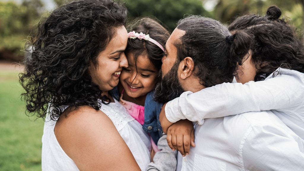 Parents sharing a loving moment with their kids