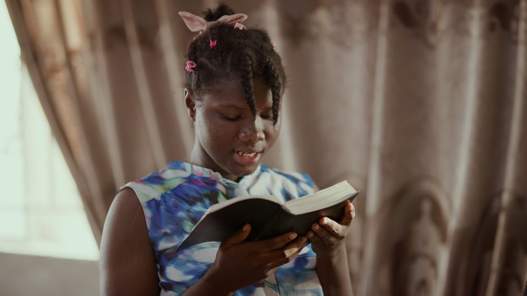 Young girl reading the Bible