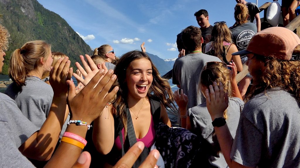 Cheering and welcoming kids to camp