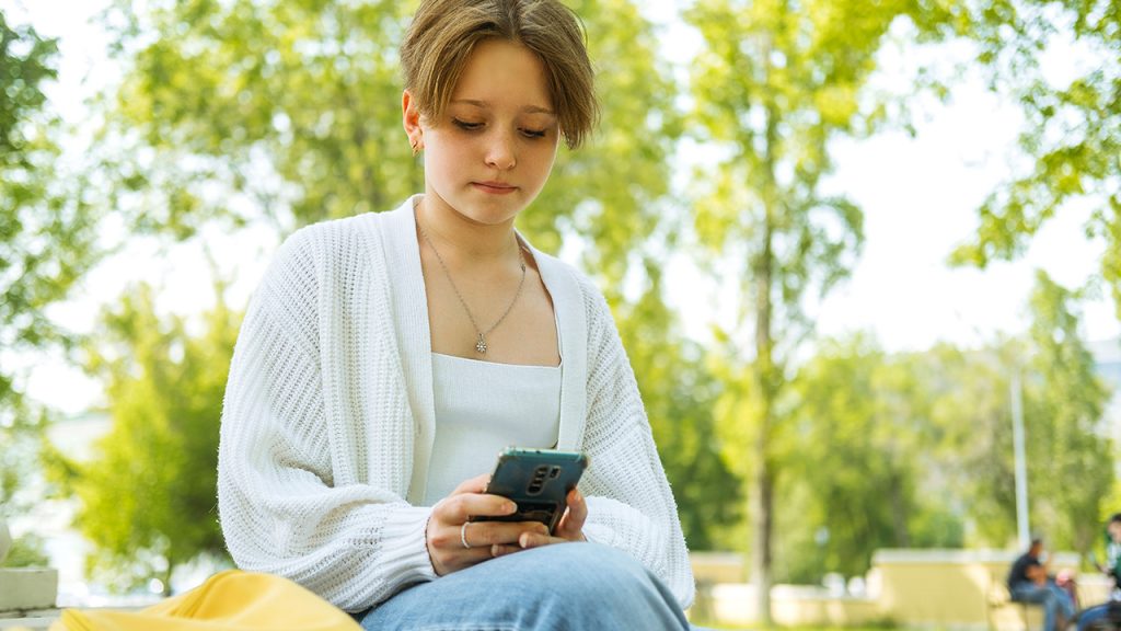 Teen reading something on her phone