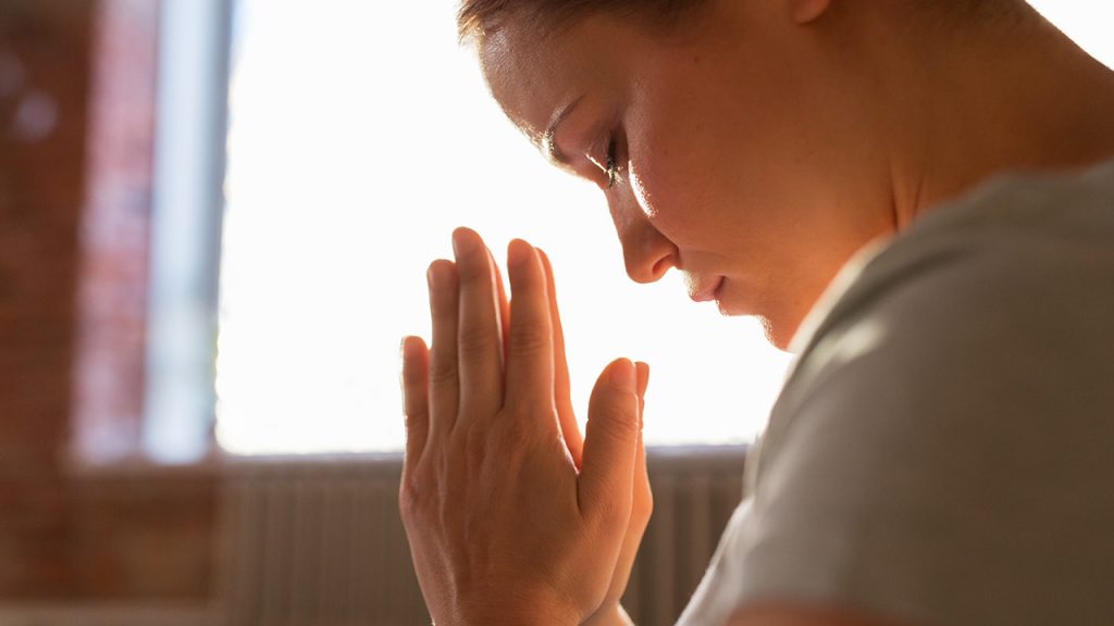 Woman praying for leaders
